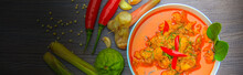Red Curry Chicken, Thai Spicy Food And Fresh Herb Ingredients On Wooden Top View / Still Life, Selective Focus