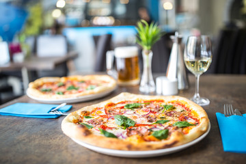 Wall Mural - The served dinner table with pizza in pizzeria or  restaurant.