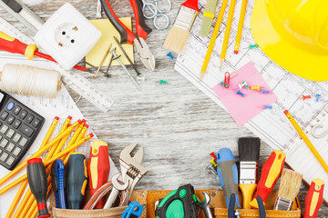 Different construction tools, wooden background