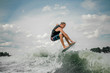 © fesenko - Young guy wakesurfing on the board down the river