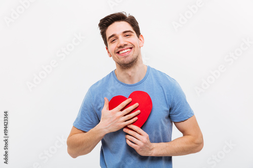 Poster Pleased man in t-shirt hugging paper heart