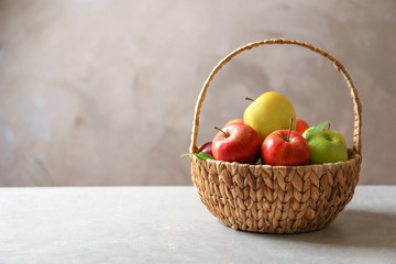 Poster - Ripe apples in wicker basket on table