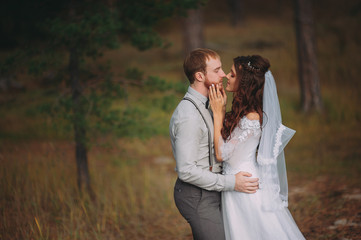 Wall Mural - stylish bride and groom walking in nature