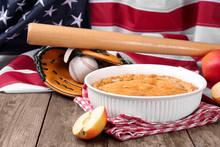 Delicious American Apple Pie With Baseball Equipment On Table Against Flag