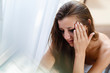 © korchemkin - Girl with blurred makeup tears crying in the corner. Depression and stress woman portrait. Broken heart woman crying alone near the window, the concept of Valentine's Day.