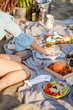 © LStockStudio - People Enjoying Food on Beach Picnic