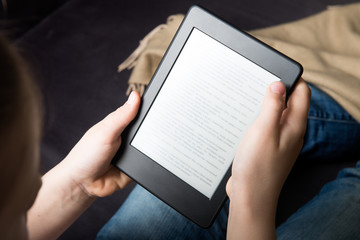 Girl is reading ebook on digital tablet device