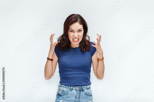 Fotografía A very frustrated and angry hatred woman isolated on white background in studio