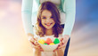 close up of girl and mother holding easter eggs