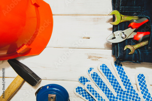 Repair carpenter tools: hummer, protective glaves, measure tape and helmet on wh Tableau sur Toile
