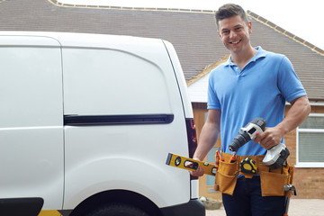 Portrait Of Builder With Van Outside House