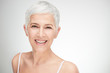 © chika_milan - Portrait of beautiful senior woman in front of white background.