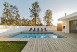 Fototapeta  - Modern house with garden swimming pool and wooden deck