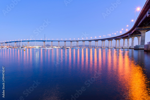 Fotografia, Obraz Coronado Bridge at Dusk - A close-up dusk view of Coronado Bridge, winding over calm San Diego Bay, at San Diego, California, USA