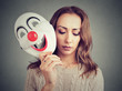 Sad woman with clown mask