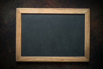 Wall Mural - Vintage chalkboard in wooden frame on darke background. 