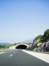 Tunnel In Road Among Mountains