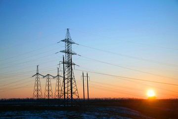 Electricity Pylon - power lines overhead power line transmission tower of the sunset.