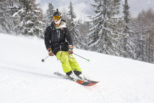Portrait Of Male Skier Smiling While Freeriding Off Piste