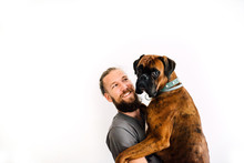 Man Hugging With Brown Boxer Dog