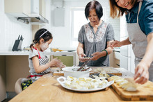 Family Cooking In Kitchen