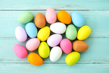 Wall Mural - Colorful Easter eggs on rustic wooden planks background. Holiday in spring season. vintage pastel color tone. top view composition.