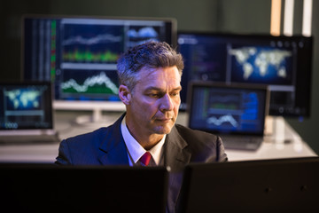 Wall Mural - Stock Market Broker Looking At Multiple Computer Screen