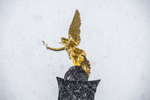 The Angel Of Peace On The Top Of Friedensengel Monument In Munich, Germany During The Snow Srorm