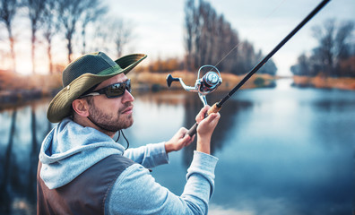 Fisherman enjoys in fishing on the river. Sport, recreation, lifestyle