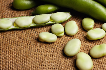 fresh broad beans on a rustic background