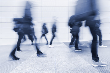 Wall Mural - blurred commuters at a modern corridor