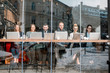 © rh2010 - Business people during the coffee break sitting with laptops near the window. View through the window with city reflection