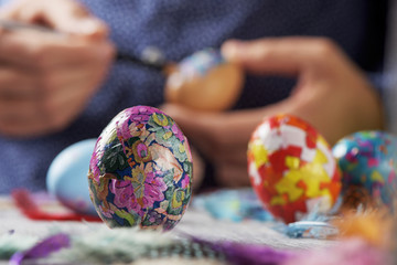 Wall Mural - young man decorating easter eggs