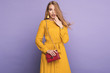 Fashionable woman in nice yellow dress, handbag and accessories. Fashion spring summer photo