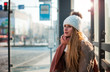 © leszekglasner - Beautiful woman in wool hat waiting at bus stop during winter day