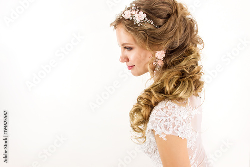 young blonde girl in a white wedding dress and jewelry in hairstyle with big cu Poster