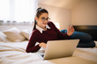 © Nebojsa - Young girl laying down on the bed and shopping online.