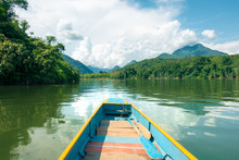 Travelling Journey South Down The Remote Nam Ou River In Laos, In A Colorful Longboat.