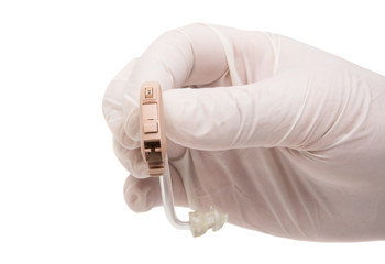 a hearing aid in the doctor's hand