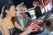 © auremar - couple in casino on a slot machine