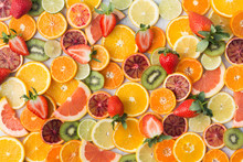 Colourful Fruit Pattern, Oranges, Clementines, Blood Oranges, Kiwis, Strawberries And Grapefruits On White Table Background, Top View, Selective Focus