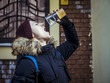 © Mihail - homeless man drinking frozen ice beer outside in the street