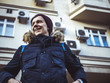 © Mihail - portrait of young smiling man walking in the europe streets with backback