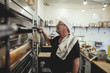 © Maskot - Baker checking oven in bakery