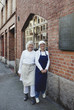 © Maskot - Portrait of smiling female bakers standing by brick wall outside bakery