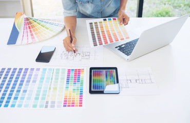 Poster - Creative creativity graphic designer working with graphics tablet,laptop and smart phone, colour chart at workplace on wooden desk , colour ideas style concept