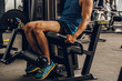 © PooMtyKunG - Closeup nice muscle runner legs with leg machine, Sport concept.
