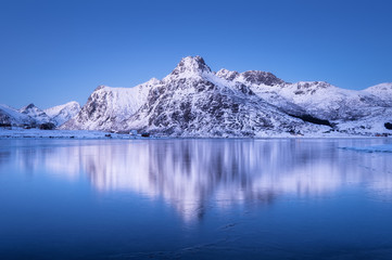 Wall Mural - Mountain ridge and reflection in the lake. Natural landscape in the Norway