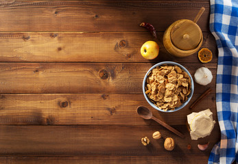 Wall Mural - cereal flakes and healthy food on wood