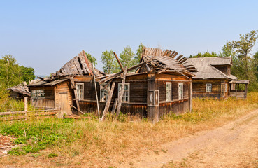 Wall Mural - Old wooden broken houses in russian abandoned village